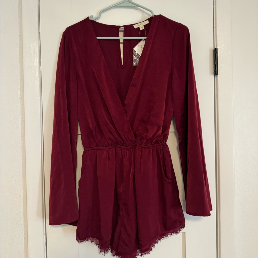 Super cute red romper new with tags! Bought for $47. Great silk quality.